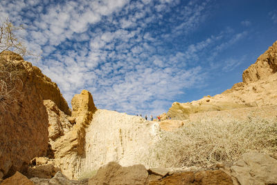 Low angle view of rocks against sky