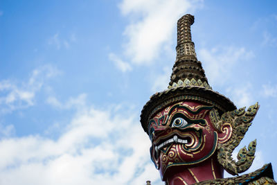 Low angle view of statue of temple against cloudy sky