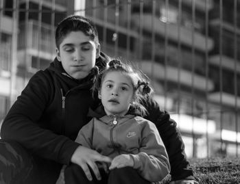 Portrait of mother with daughter in city at night