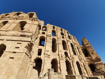 Low angle view of historical building against clear blue sky