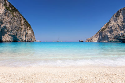 Scenic view of sea against clear blue sky