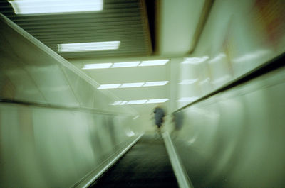 Blurred motion of person walking in subway