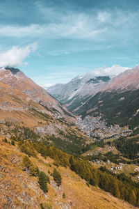 Scenic view of valley and mountains against sky