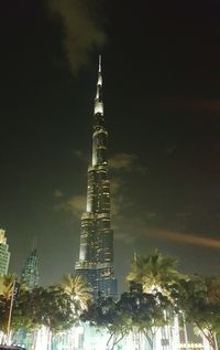 Low angle view of modern building against sky at night