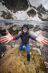 Portrait of young man standing on rock