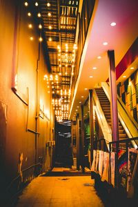 Illuminated corridor of building at night