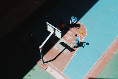 High angle view of boys playing basketball at court
