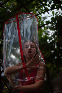 Low angle view of young woman shows tongue