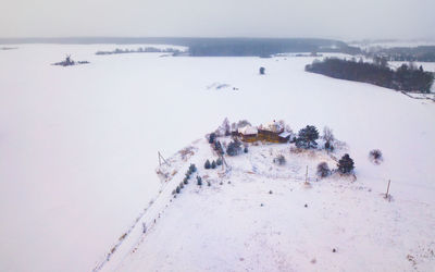 High angle view of snow covered land against sky