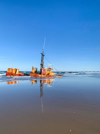 Scenic view of sea against clear blue sky