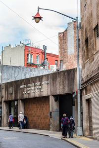 People walking towards post office in city