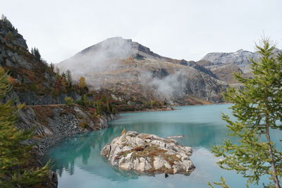 Scenic view of lake and mountains against sky