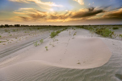 Scenic view of beach against sky during sunset