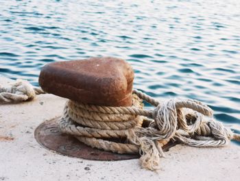 Close-up of rope tied on wooden post