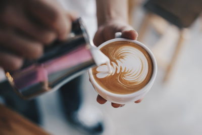 Close-up of person making coffee