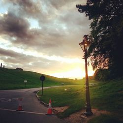 Scenic view of grassy field against cloudy sky