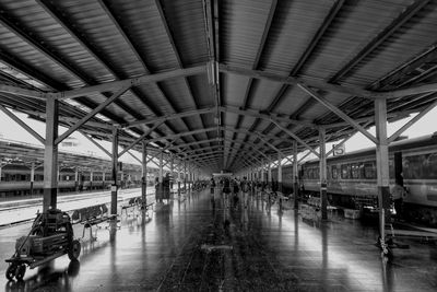 Train moving at railroad station by building