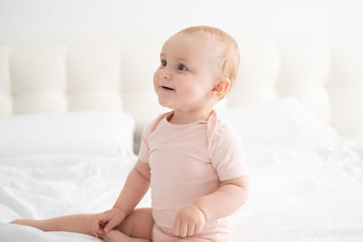 Cute baby playing on bed