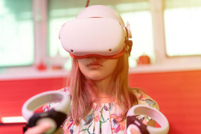 Vr game and virtual reality. kid girl gamer fun playing on futuristic simulation video shooting game