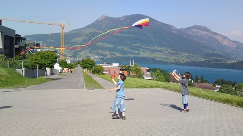Kids playing outdoors with kite