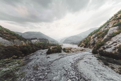 Road amidst mountains against sky