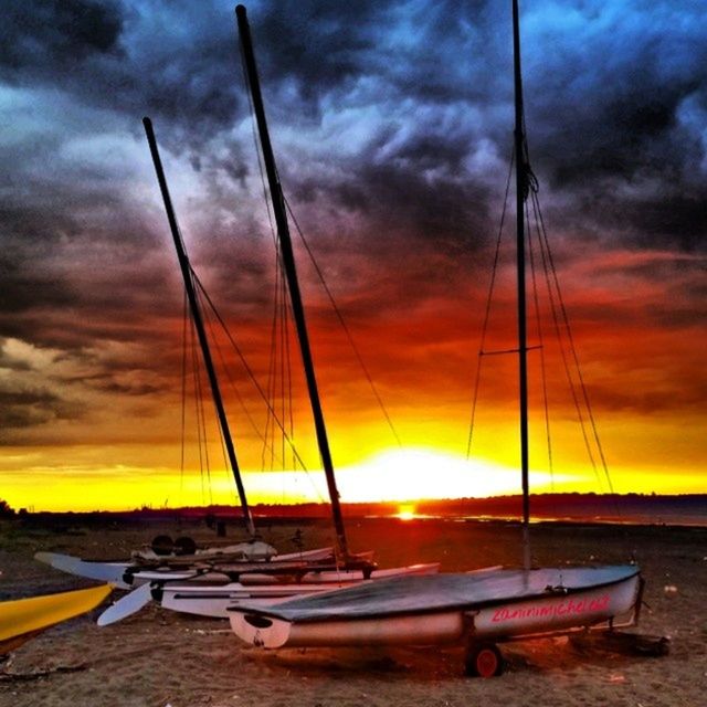 sunset, transportation, nautical vessel, sky, boat, mode of transport, water, cloud - sky, sea, orange color, moored, scenics, beauty in nature, tranquility, cloudy, tranquil scene, sun, mast, cloud, nature