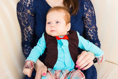 Portrait of mother carrying daughter at home