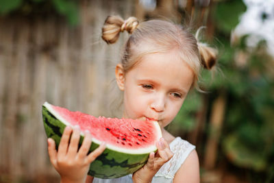 Portrait of cute girl eating food