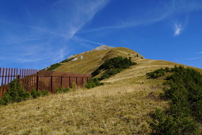 Scenic view of land against blue sky