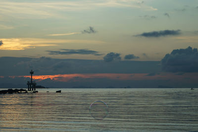 Scenic view of sea against cloudy sky