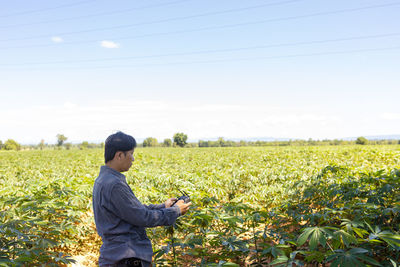 Side view of man standing on field