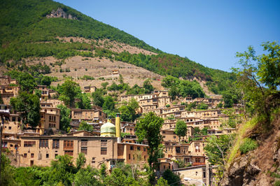 Buildings in town against clear sky