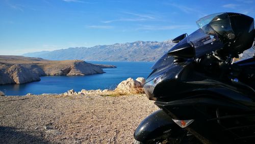 Panoramic view of sea and mountains against sky