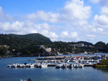 Boats moored in lake against sky