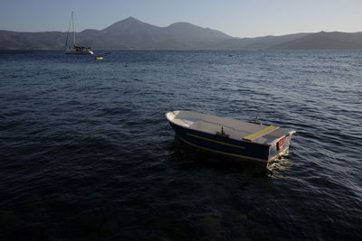 Local fishing boat on sea against sky