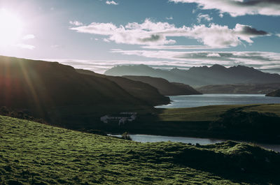 Scenic view of sea and mountains against sky