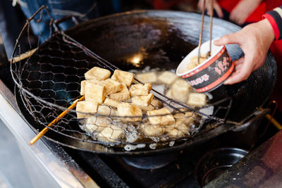 Cropped image of vender preparing food