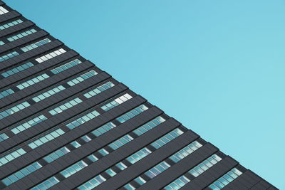 Low angle view of building against clear blue sky