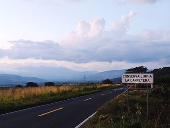 Road sign against sky