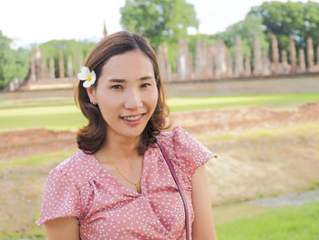 Portrait of smiling woman standing outdoors