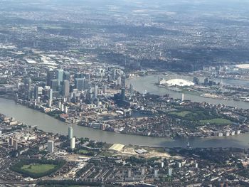 High angle view of city by river against sky