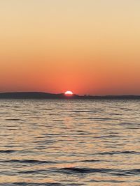 Scenic view of sea against romantic sky at sunset
