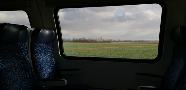 Field seen through train window