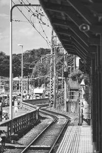Train at railroad station against sky