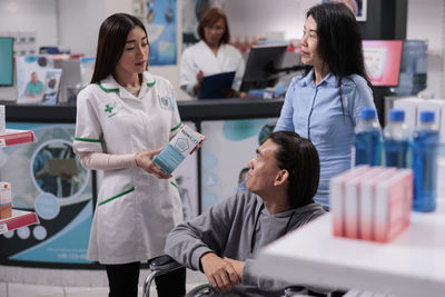 Portrait of doctor examining patient in office