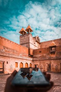 View of old building against cloudy sky