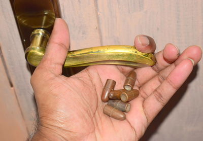 Close-up of man hand holding bullets