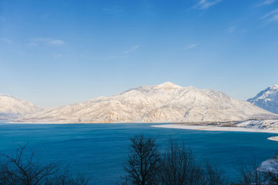 Charvak reservoir with blue water on a clear winter day in uzbekistan