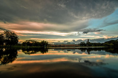 Scenic view of lake against sky at sunset