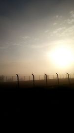 Scenic view of field against sky at sunset